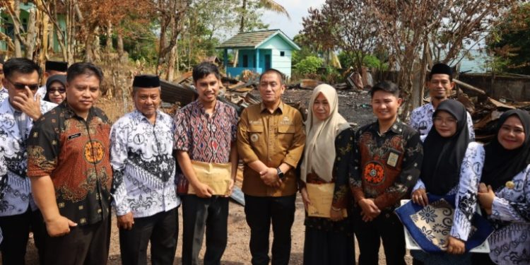 Bupati Luwu Timur, Irwan Bachri Syam bersama sejumlah pengurus PGRI Lutim menyambangi korban kebakaran di SMPN 1 Wasuponda, Kamis 24 Juli 2025. (Foto: Warta Lutim)